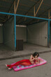 © Alina Hvostikova/Stocksy - Woman Relaxing on swimming mattress in Urban Setting