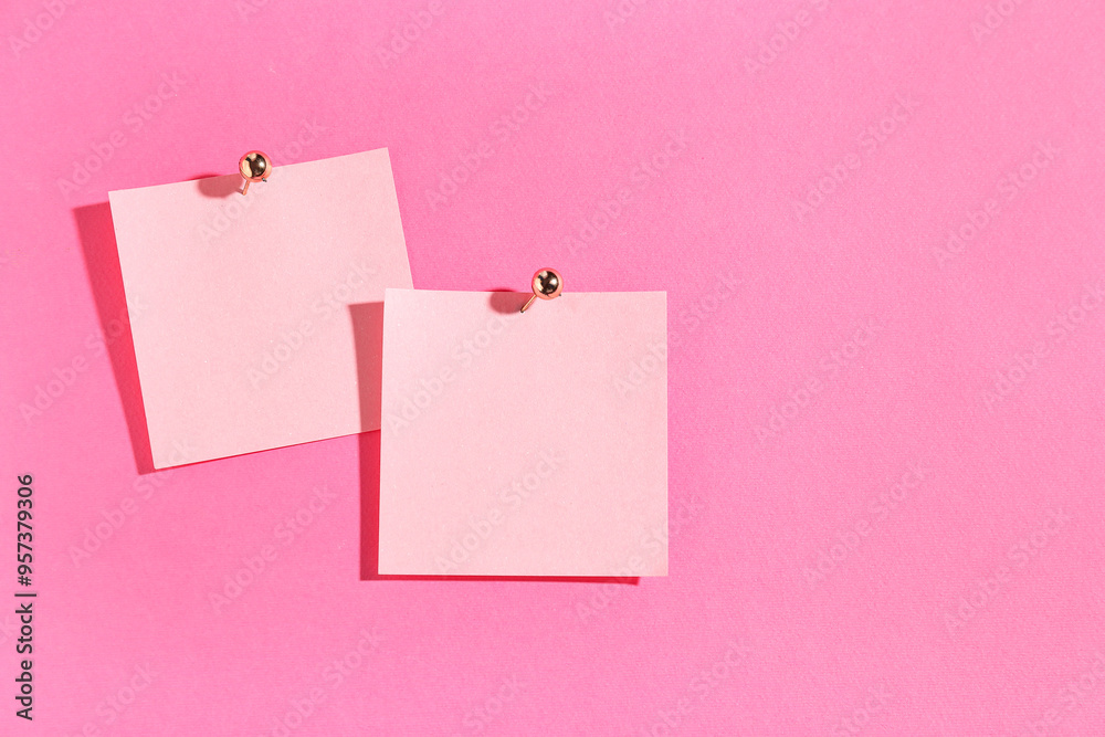 Paper notes pinned on pink background