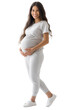 © Carmen - Full body view of young Hispanic pregnant woman dressed in white exercise clothes, isolated on png transparent background