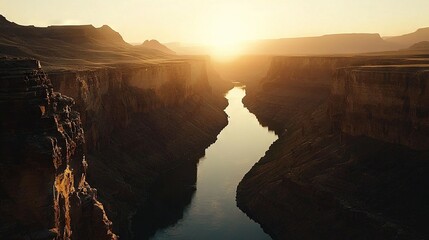 Sticker -   A canyon with a river runs beneath the setting sun, which is positioned behind a distant mountain range