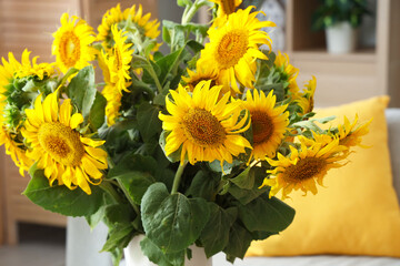 Vase of sunflowers bouquet in living room, closeup