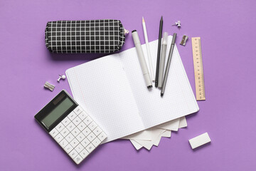 Wall Mural - Blank notebook with pencil case and different stationery supplies on purple background