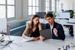 © BONNINSTUDIO/Stocksy - Two focused business people working together in office