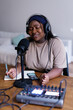 © Oleksii Syrotkin/Stocksy - Black body positive woman smiling while creating content for podcast