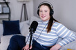 © Oleksii Syrotkin/Stocksy - Portrait of happy podcaster working from home and recording content