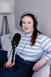 © Oleksii Syrotkin/Stocksy - Portrait of plus size podcaster recording content for her social media