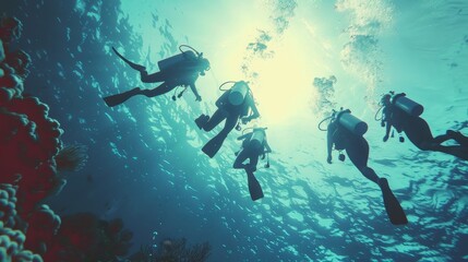 Canvas Print - A group of four scuba divers are swimming in the ocean