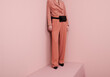© Ulas&Merve/Stocksy - Fashion Model Wearing Pink Suit and Black Accessories