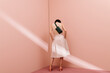 © Ulas&Merve/Stocksy - Minimalist Woman Standing Against Pink Wall in Natural Light