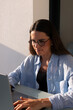 © Adrian Rodd/Stocksy - Close up of an entrepreneur managing her digital enterprise from home