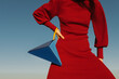 © Ulas&Merve/Stocksy - Fashion Model In Red Dress Posing With Unique Geometric Handbag