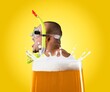© BillionPhotos.com - Man in swimsuit floating at top of foamy beer glass