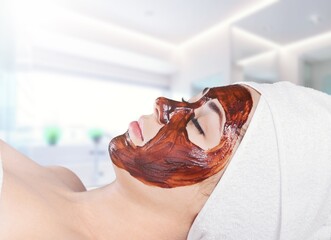 Wall Mural - Cosmetologist applying mask on face of woman