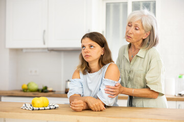 Wall Mural - Old woman encouraging her daughter, embracing her. Mother consoling her daughter.