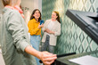 © Franci Leoncio - Colleagues laughing and chatting near a copier in a modern office
