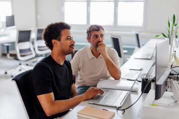 Two men working together in a modern office
