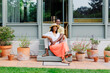 © BONNINSTUDIO/Stocksy - Happy couple sitting on stairs in front of house