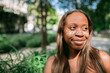 © Olga Romanova/Stocksy - Portrait of a happy african american woman with flower freckles