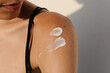 © Adrian Rodd/Stocksy - Shoulder of an unidentified woman with sunscreen applied to her skin
