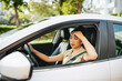 © Marc Tran/Stocksy - Stressed, desperate woman driver with documents sitting inside