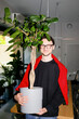 © Artem Podrez/Stocksy - Smiling Colleague with Office Plant