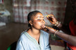 © Alvaro Lavin/Stocksy - Makeup artist applying makeup to black woman in senegal, africa