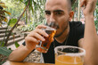 © Laura Herrera/Stocksy - Young Man Drinking Beer at Outdoors