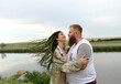 © Anna Artemenko/Stocksy - man and woman hugging by the river