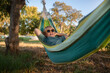 © Iryna Auhustsinovich/Stocksy - boy relaxing in the hammock