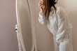 © Inna Reznik/Stocksy - Mid-life Woman Examining Herself in a Mirror