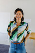 © BONNINSTUDIO/Stocksy - Businesswoman smiling in modern office space