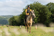 © Alvaro Lavin/Stocksy - Young woman practicing horseback riding in an equestrian center