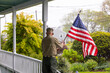 © Raymond Forbes LLC/Stocksy - Senior military man Veteran display American Flag at Home