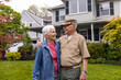 © Raymond Forbes LLC/Stocksy - Veteran Portrait at home  with wife family front of house summer