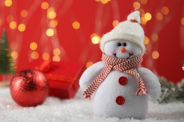 Wall Mural - Cute decorative snowman on artificial snow, closeup. Space for text