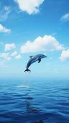 A joyful dolphin leaps gracefully above the clear blue ocean, showcasing the beauty of marine life against a serene sky.