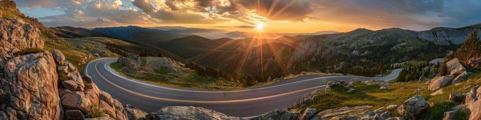 Wall Mural - Scenic view of a winding road at sunrise among the mountains.