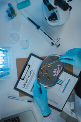 Wall Mural - a scientist is testing various pills in order to improve their quality an effectiveness in the labor