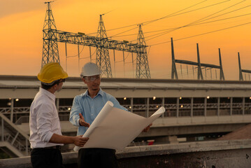 Two men engineer look at blueprint architecture building contractor design in modern city development. Males engineer holding project planing partner teamwork. Man meeting together construction site