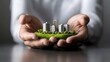 © AI Studio - Hands Holding Green City Model with Eco-Friendly Buildings