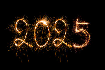 Happy New Year 2025. Burning sparkling text 2025 isolated on black background.