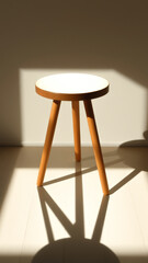 Canvas Print - Wooden stool with white top casting a shadow on a light colored floor