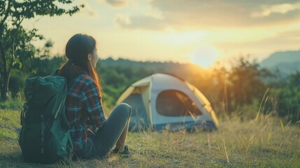 Asian women visit and camp by themselves in Thailand's natural parks. Outdoor recreation and travel with an active lifestyle. Greetings and happy beginning of the day.
