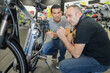 © auremar - man checks bike before buying in sports shop