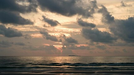 Wall Mural - timelapse of dramatic sunrise with orange sky in a cloudy day at the ocean.