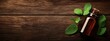 © Mikus - A bottle of peppermint essential oil and fresh mint leaves against a wooden backdrop Include text here