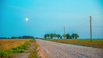 Wall Mural - The waxing moon crosses the sky over rural farmland fields - time lapse