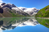 Fototapeta Zachód słońca - Panoramic view of Reservoir Mooserboden lake in mountains of the Hohe Tauern near Kaprun, Austria Alps.