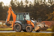 © AlexGo - Backhoe loader performing roadside construction tasks