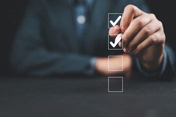 Poster - Businessman use pen to tick correct sign mark in checkbox for quality document control checklist and business approve project concept.